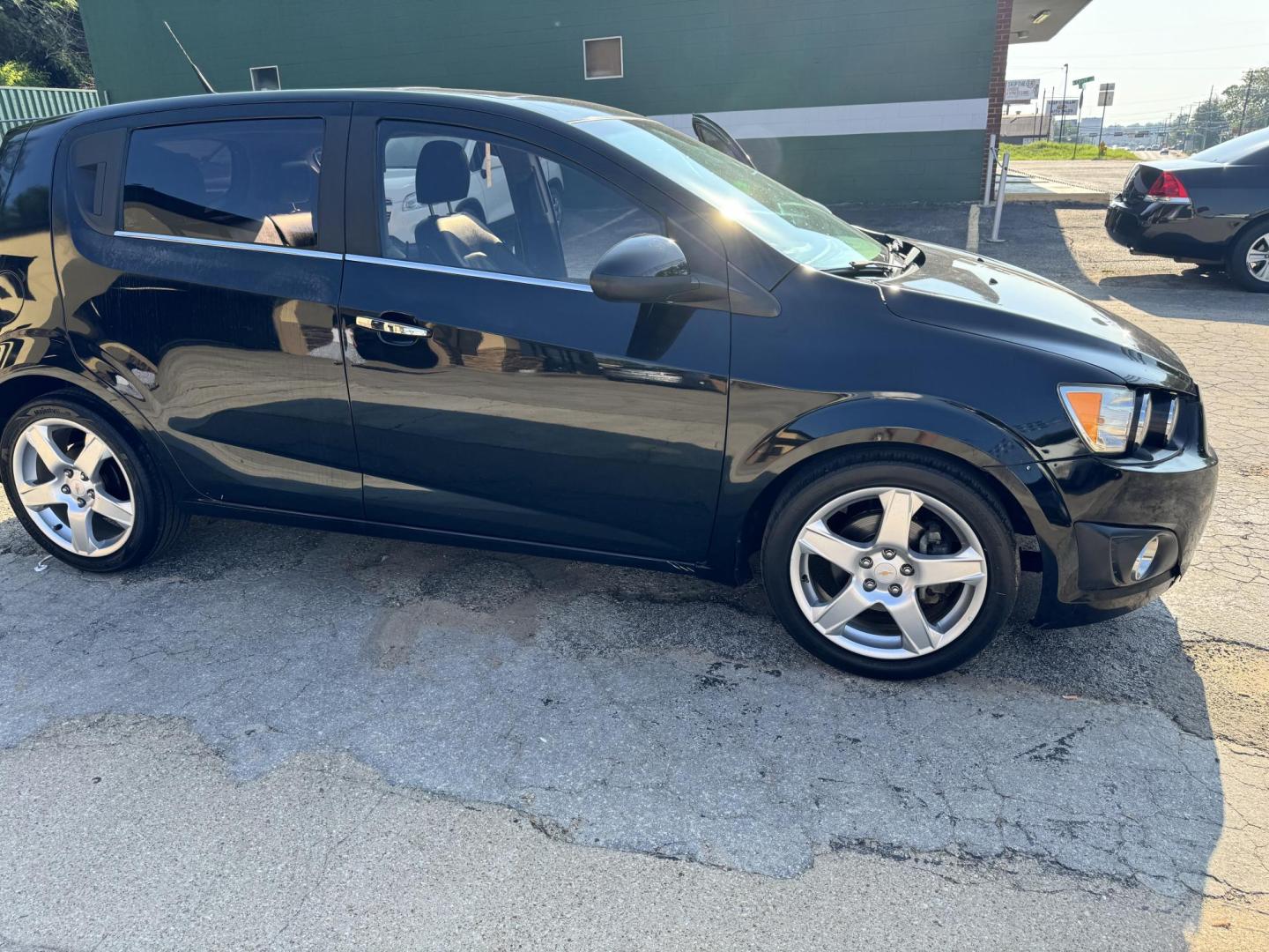 2012 BLACK Chevrolet Sonic LTZ 5-Door (1G1JE6SH2C4) with an 1.8L L4 DOHC 24V FFV engine, 6-Speed Automatic transmission, located at 307 West Marshall Avenue, Longview, TX, 75601, (903) 753-3091, 32.500828, -94.742577 - Photo#1