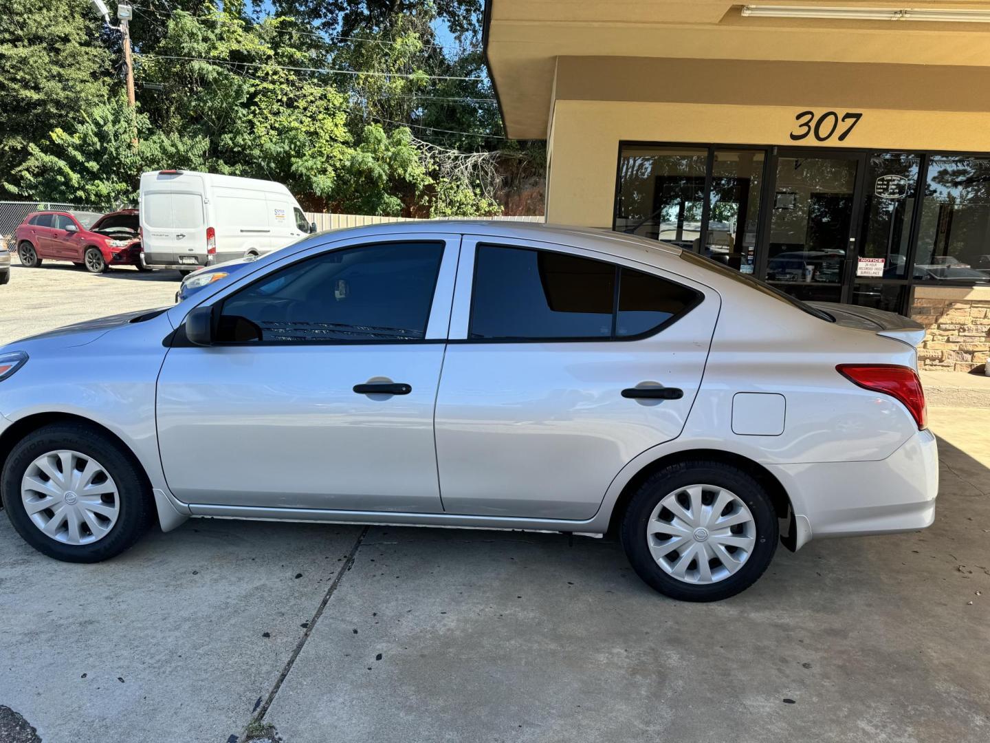 2015 SILVER Nissan Versa 1.6 S 5M (3N1CN7AP0FL) with an 1.6L L4 DOHC 16V engine, 5-Speed Manual transmission, located at 307 West Marshall Avenue, Longview, TX, 75601, (903) 753-3091, 32.500828, -94.742577 - Photo#2