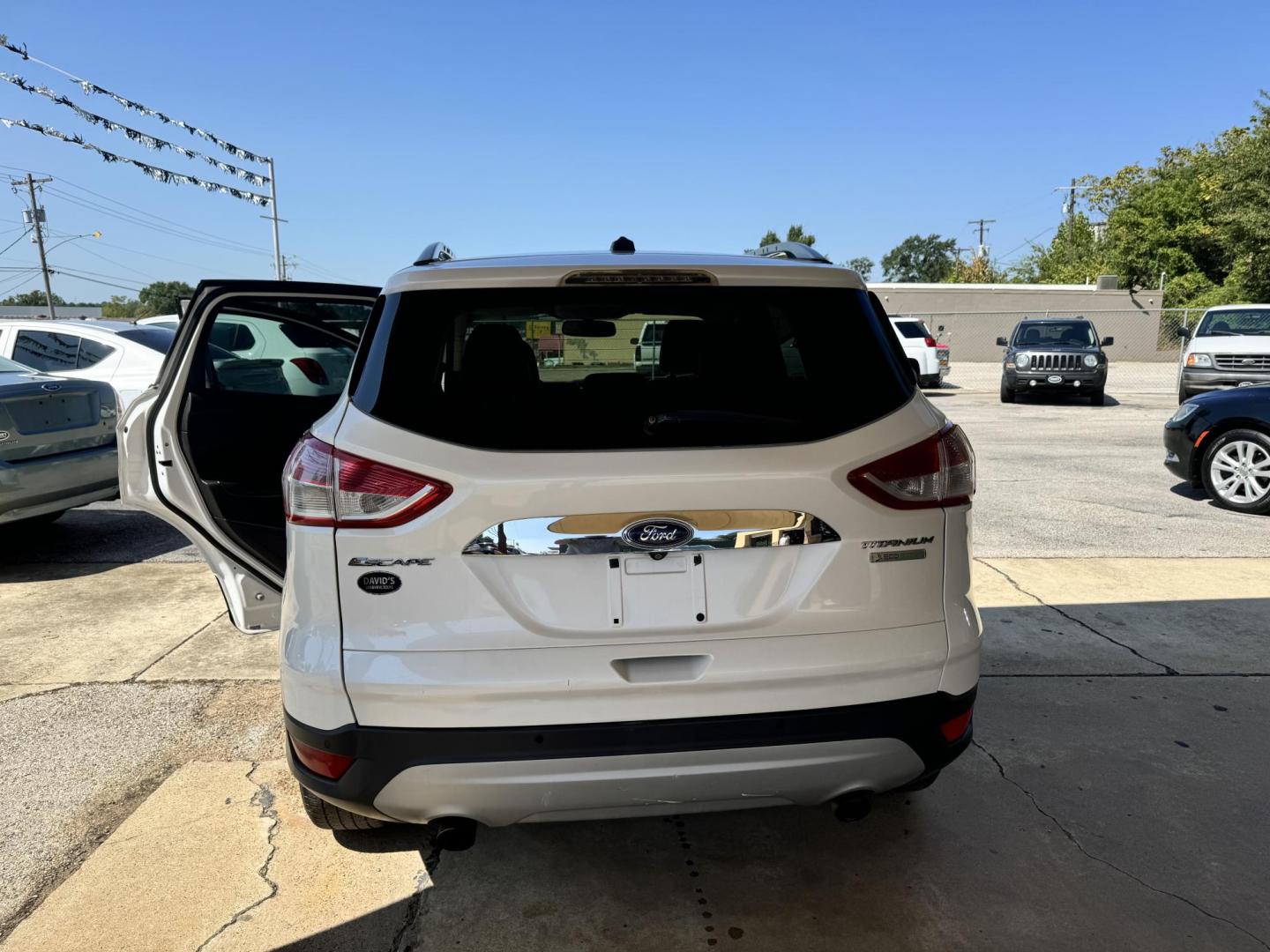 2014 White Ford Escape Titanium FWD (1FMCU0J96EU) with an 2.0L L4 DOHC 16V engine, 6-Speed Automatic transmission, located at 307 West Marshall Avenue, Longview, TX, 75601, (903) 753-3091, 32.500828, -94.742577 - Photo#1