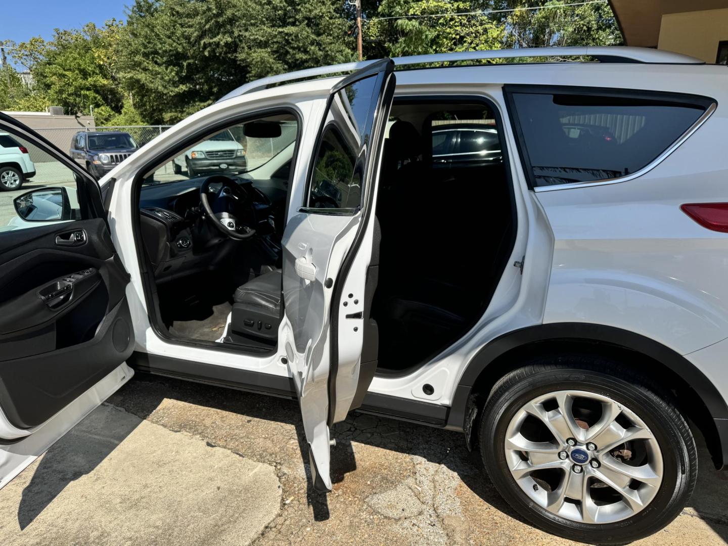 2014 White Ford Escape Titanium FWD (1FMCU0J96EU) with an 2.0L L4 DOHC 16V engine, 6-Speed Automatic transmission, located at 307 West Marshall Avenue, Longview, TX, 75601, (903) 753-3091, 32.500828, -94.742577 - Photo#2