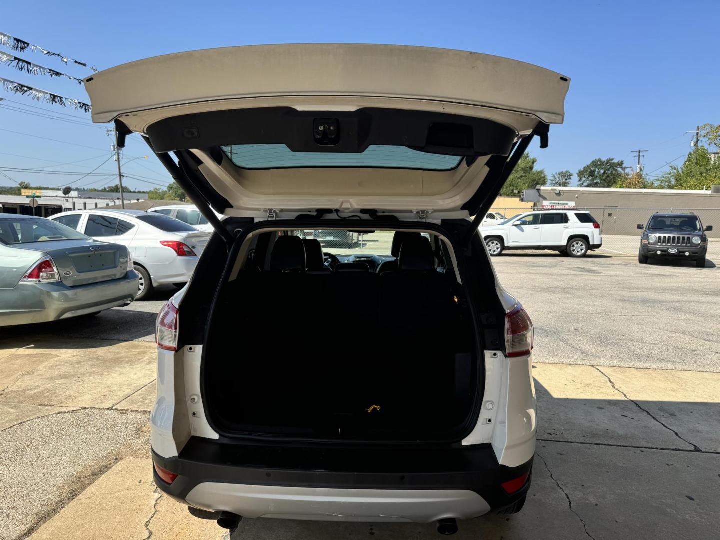 2014 White Ford Escape Titanium FWD (1FMCU0J96EU) with an 2.0L L4 DOHC 16V engine, 6-Speed Automatic transmission, located at 307 West Marshall Avenue, Longview, TX, 75601, (903) 753-3091, 32.500828, -94.742577 - Photo#4